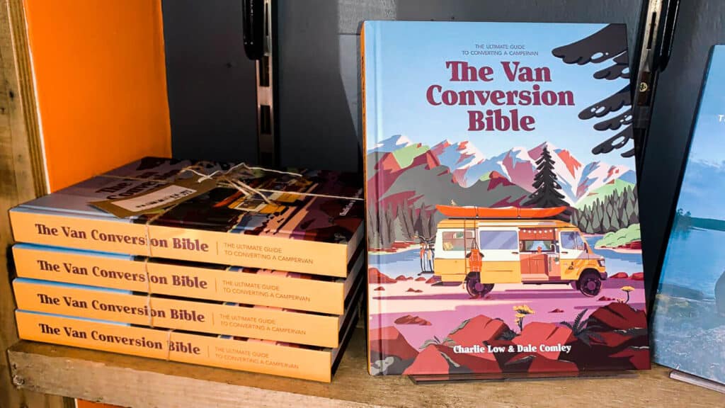 The Van Conversion Bible Book Sat On A Shelf With A Stack Of The Books Laid Sideways Next To It